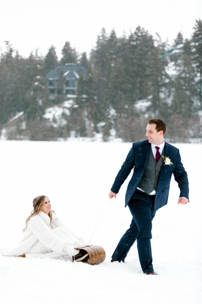 winter bride and groom with sled