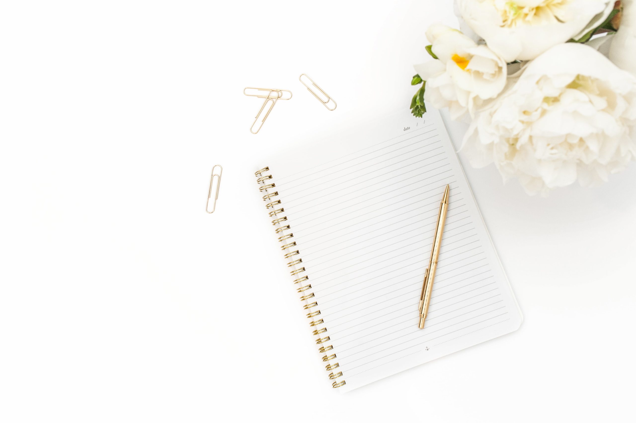 white flowers and notepad