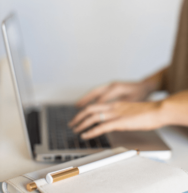 Email Marketing Specialist typing on laptop